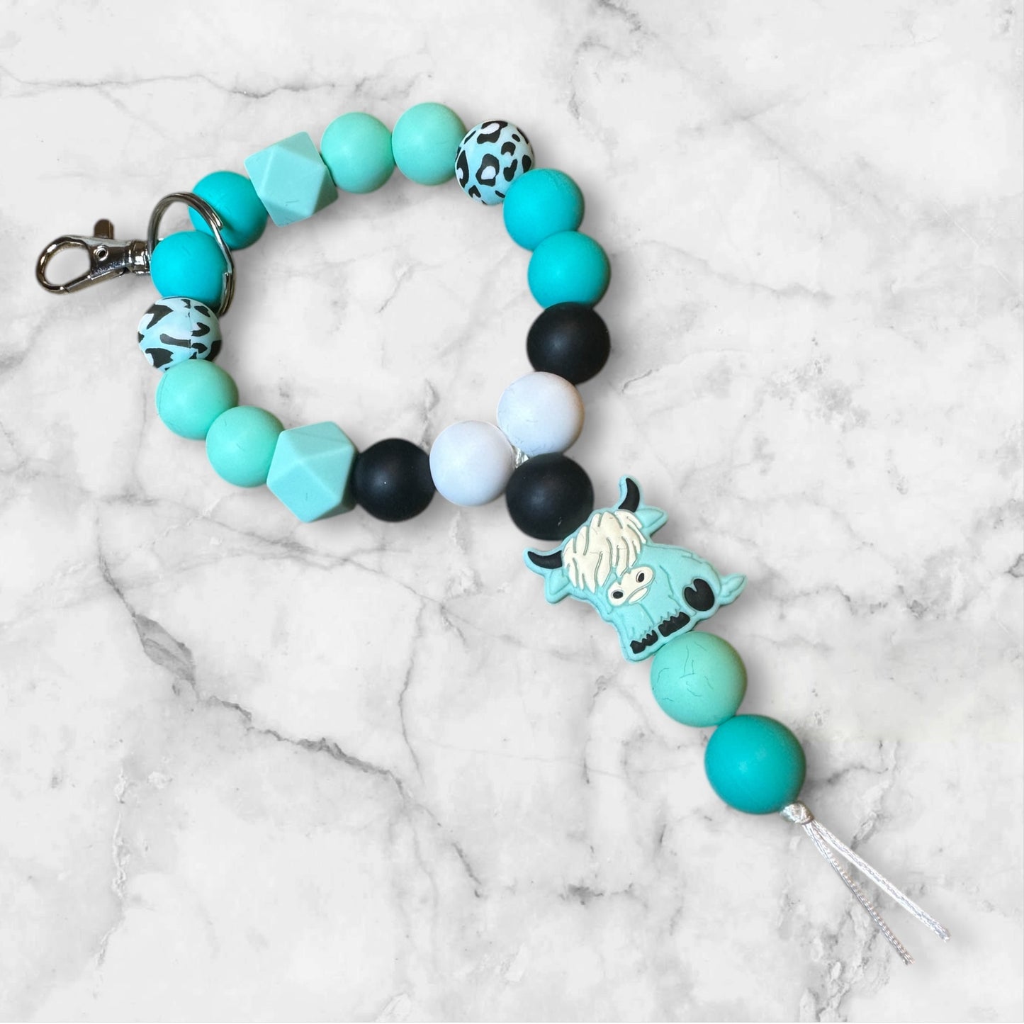 Teal cow wristlet